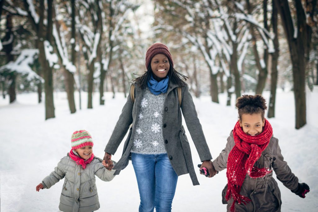Mother and two children in a snowy park