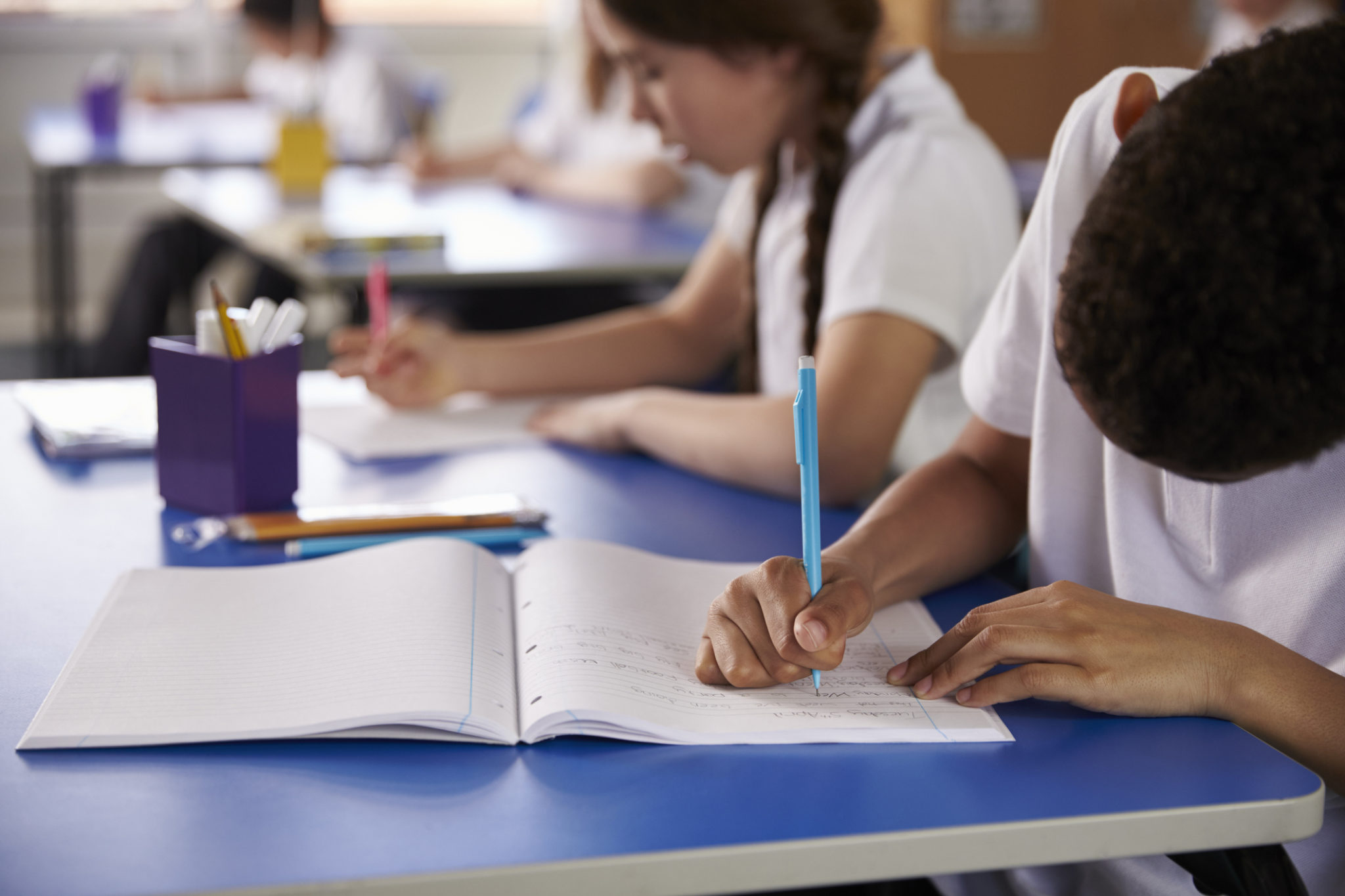 Students writing in their notebooks