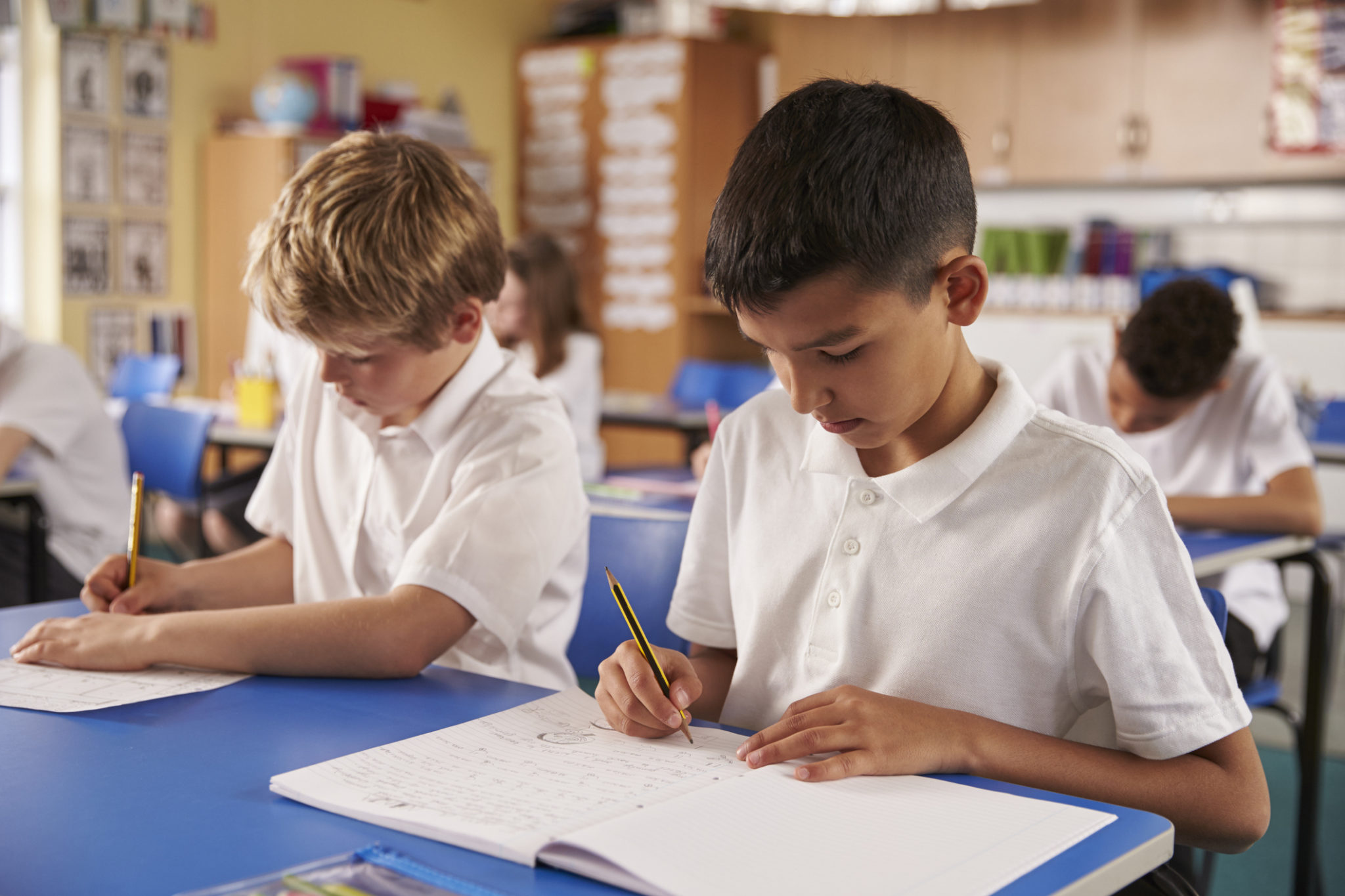 Two boys practicing 11 Plus comprehension in the classroom