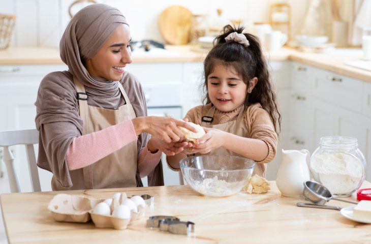 Mother and child baking together to practice maths